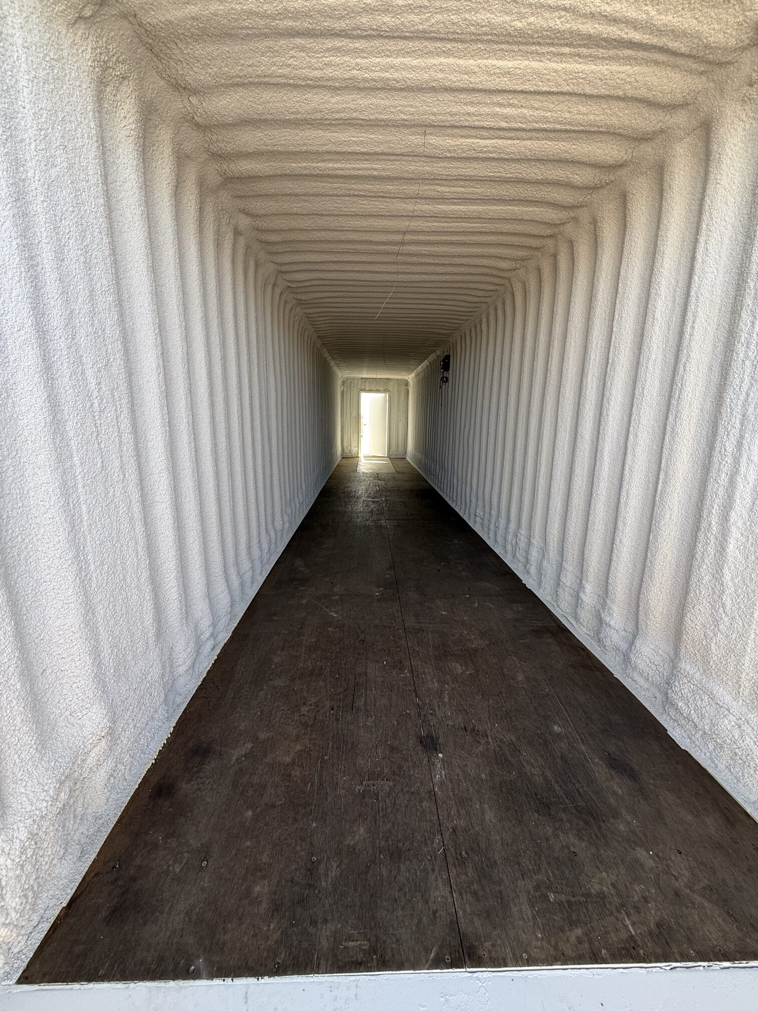 Interior of a spray foam insulated 45-foot high cube shipping container built by Conex Creation & Supply for temperature-controlled storage in Southern Arizona.